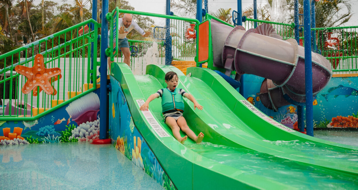Little boy goes down waterslide at North Star Holiday Resort