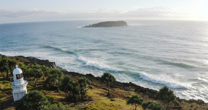Breathtaking Tweed Coast: Golden beaches, turquoise waters, and lush landscapes under a clear blue sky.