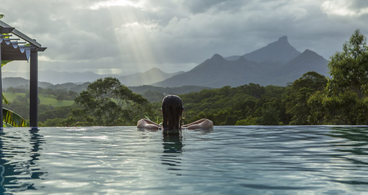 girl in pool looking out to wollumbin mount warning