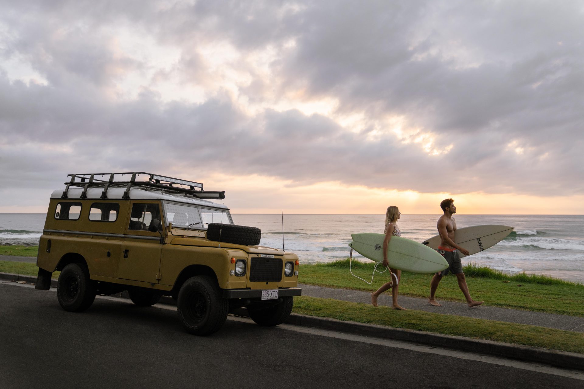 couple with surfboards retro landcruiser