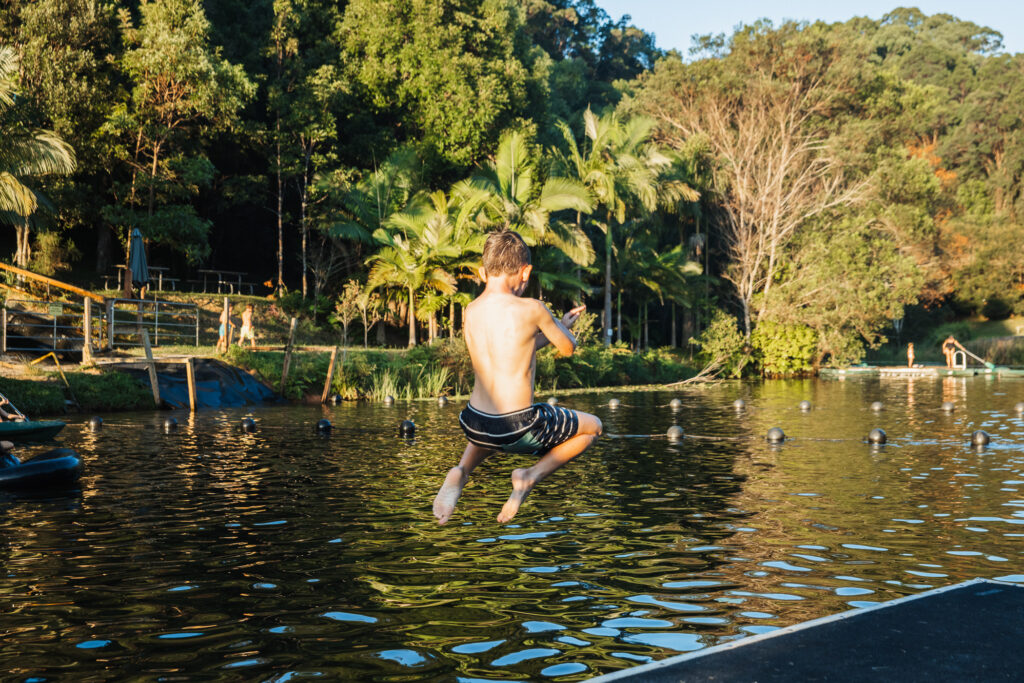 Kid jumping into dam at Hosanna Farmstay