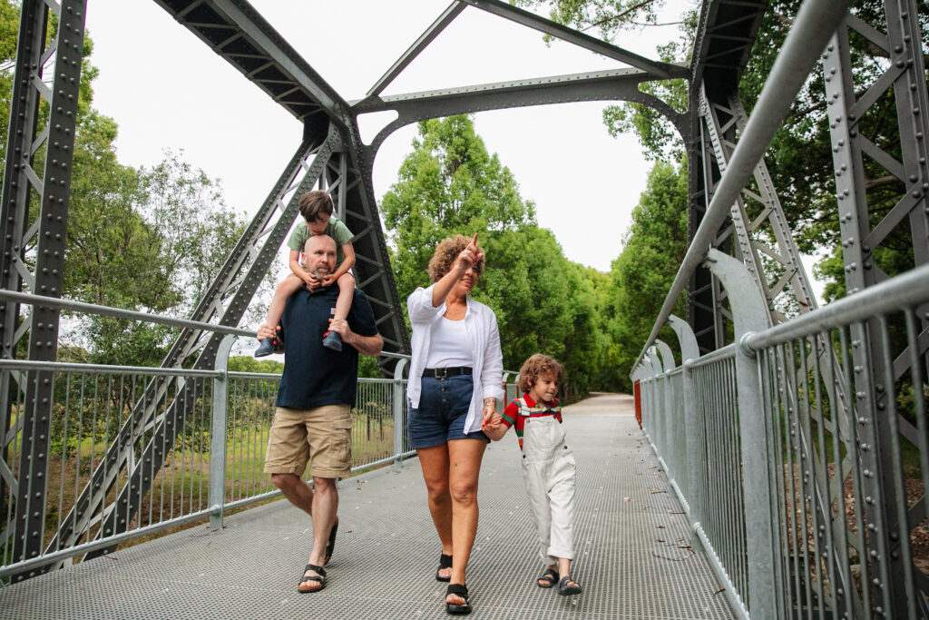 Family walking under Dunbible Creek Bridge on the Northern Rivers Rail Trail