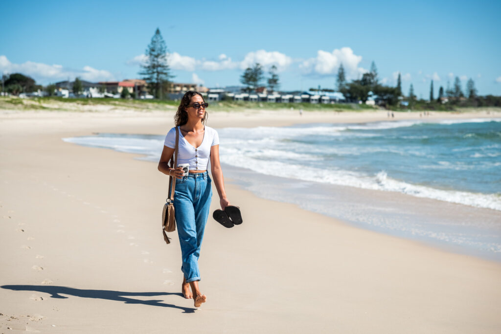 girl walking on kingscliff beach