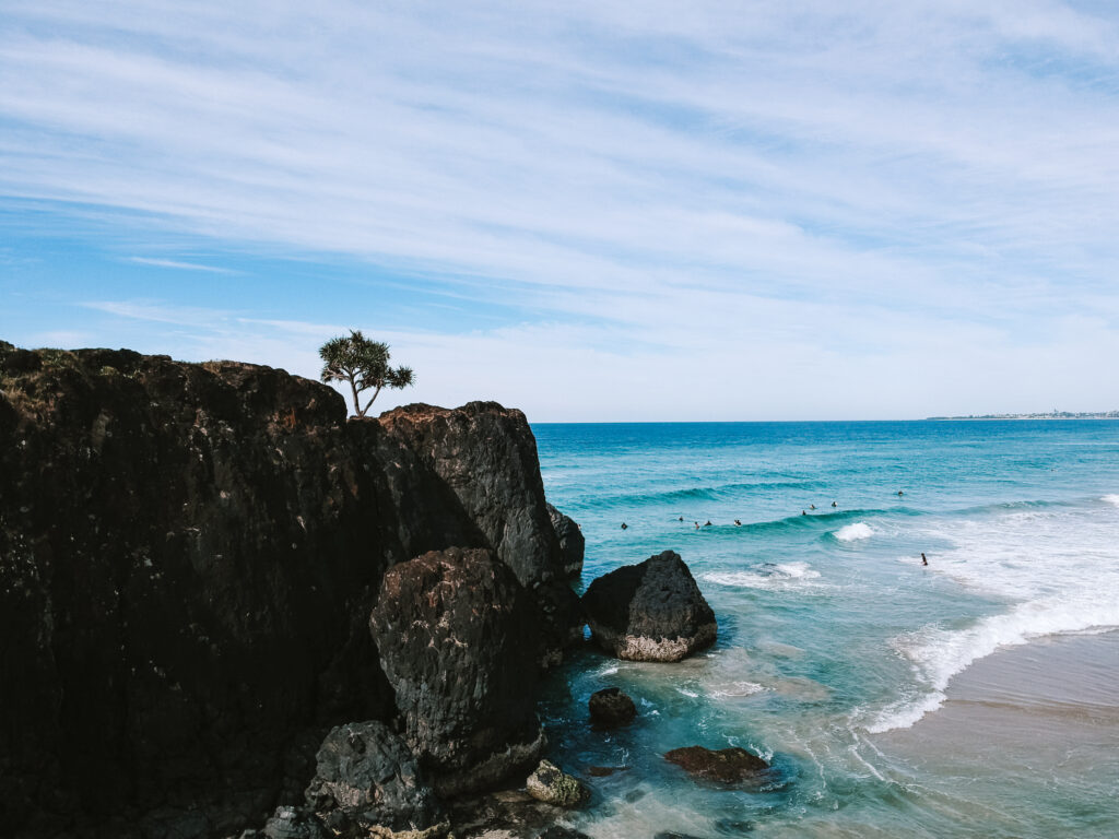 Blue waters crash on the headland of Dreamtime Beach