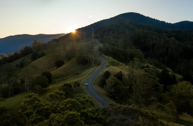 planning an ev holiday banner image of car in hinterland